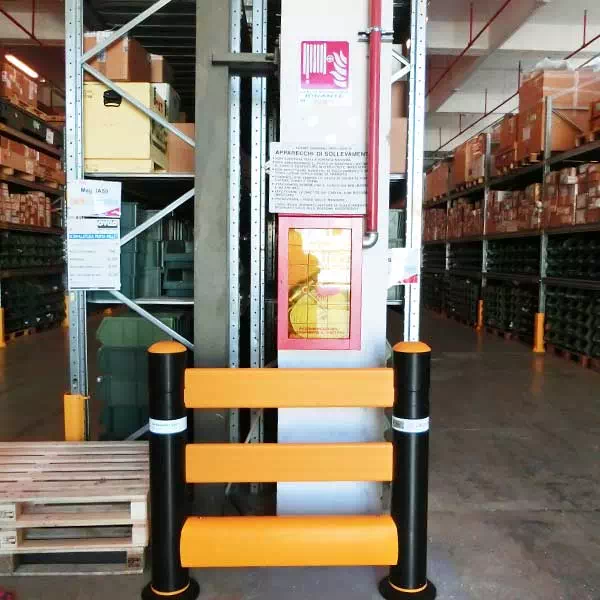 Compact barrier with three horizontal rails shielding a pillar-mounted fire extinguisher
